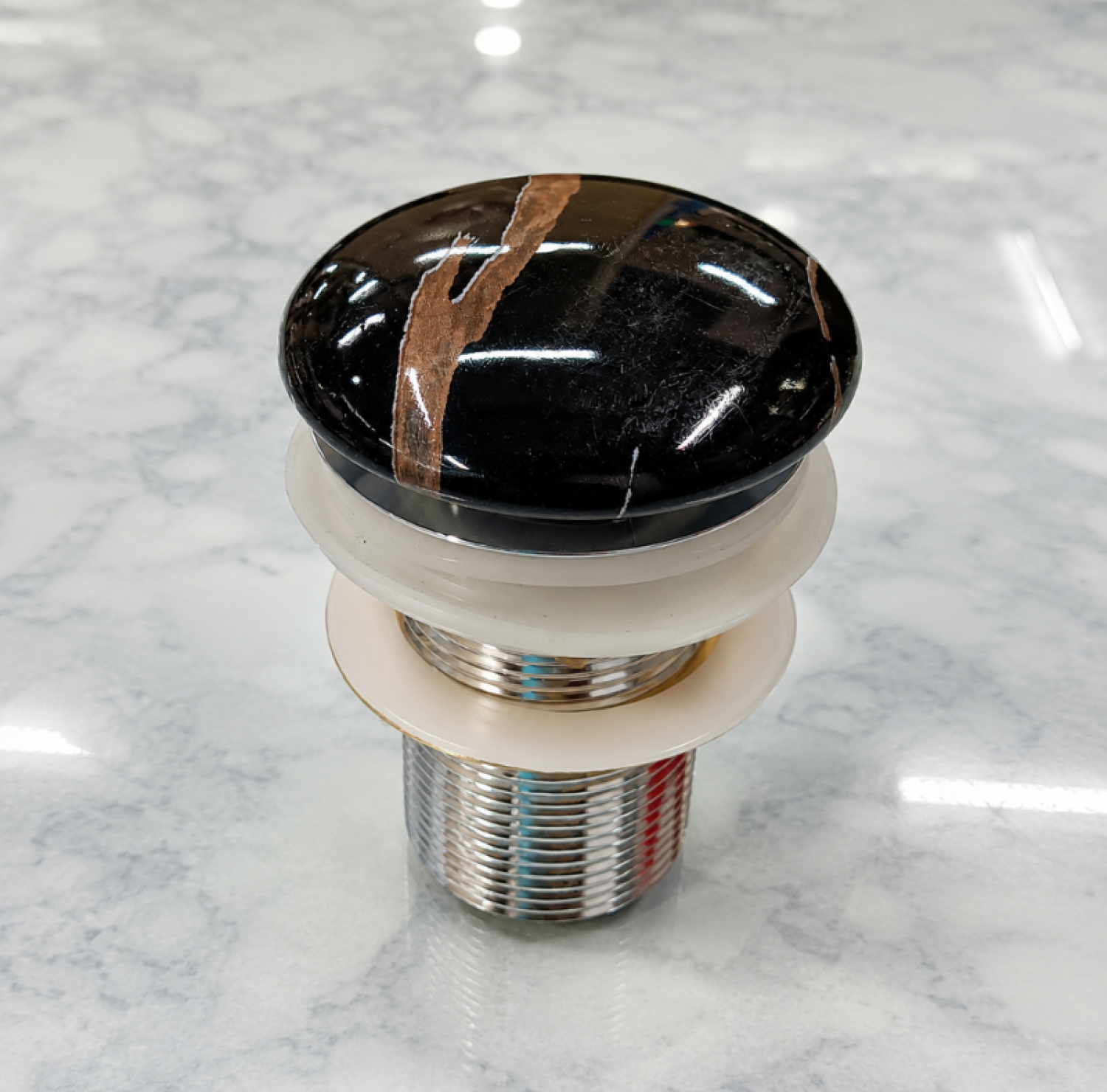 Premium Black and Red Marble Shed Basin Waste with a glossy decorative marble cap, solid brass chrome body, leak-proof click-clack push mechanism, and durable construction for countertop and vessel wash basins.